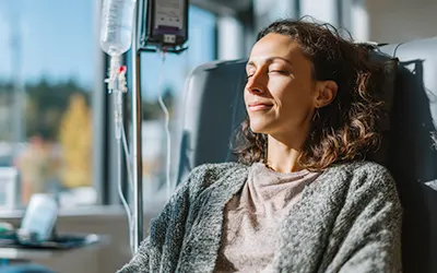 Patient receiving medically supervised ketamine infusion therapy as part of addiction treatment in a clinical setting.